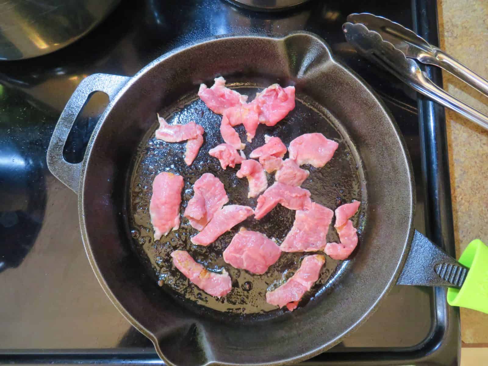 Frying the beef in a cast iron skillet