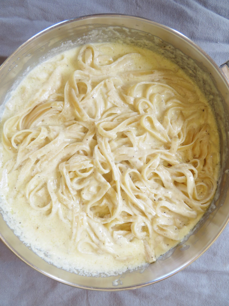 Fettuccine alfredo pasta in the skillet ready to be served.