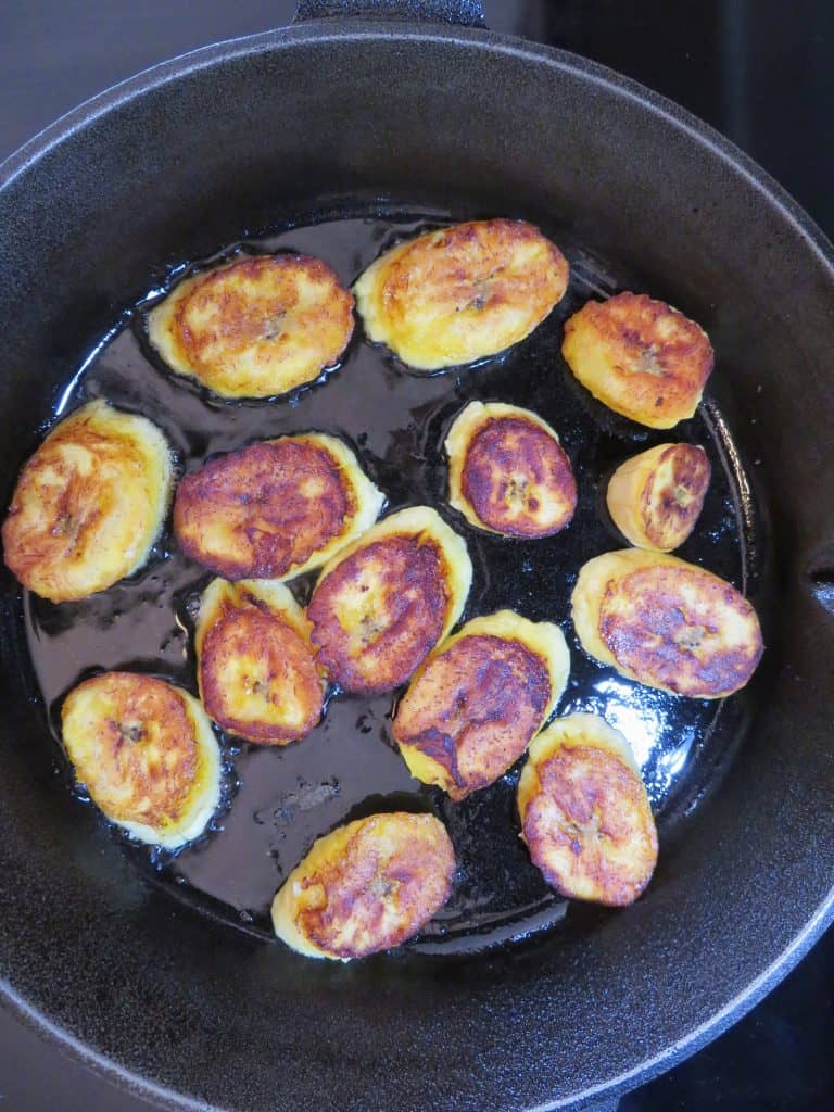 Fried plantains in a cast iron skillet.