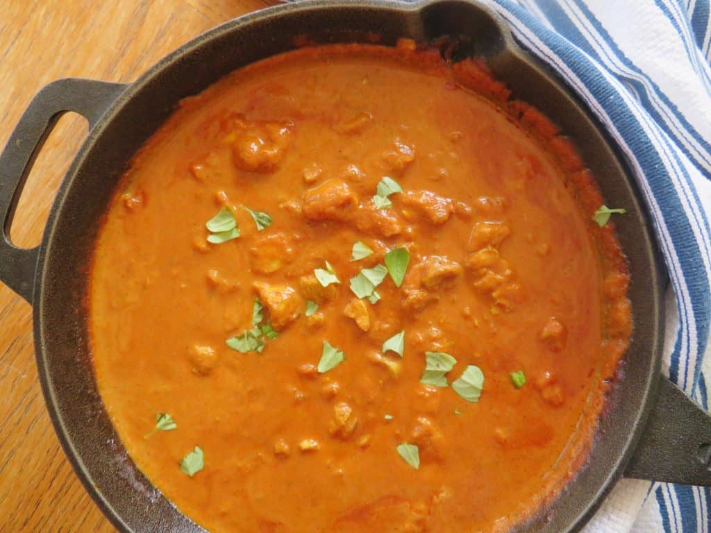Spiced curry chicken tikka masala with fresh basil leaves. - The Midwest Kitchen Blog