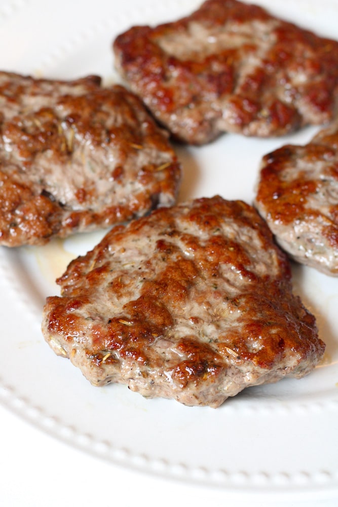 Close up image on cooked lamb burgers on a plate.