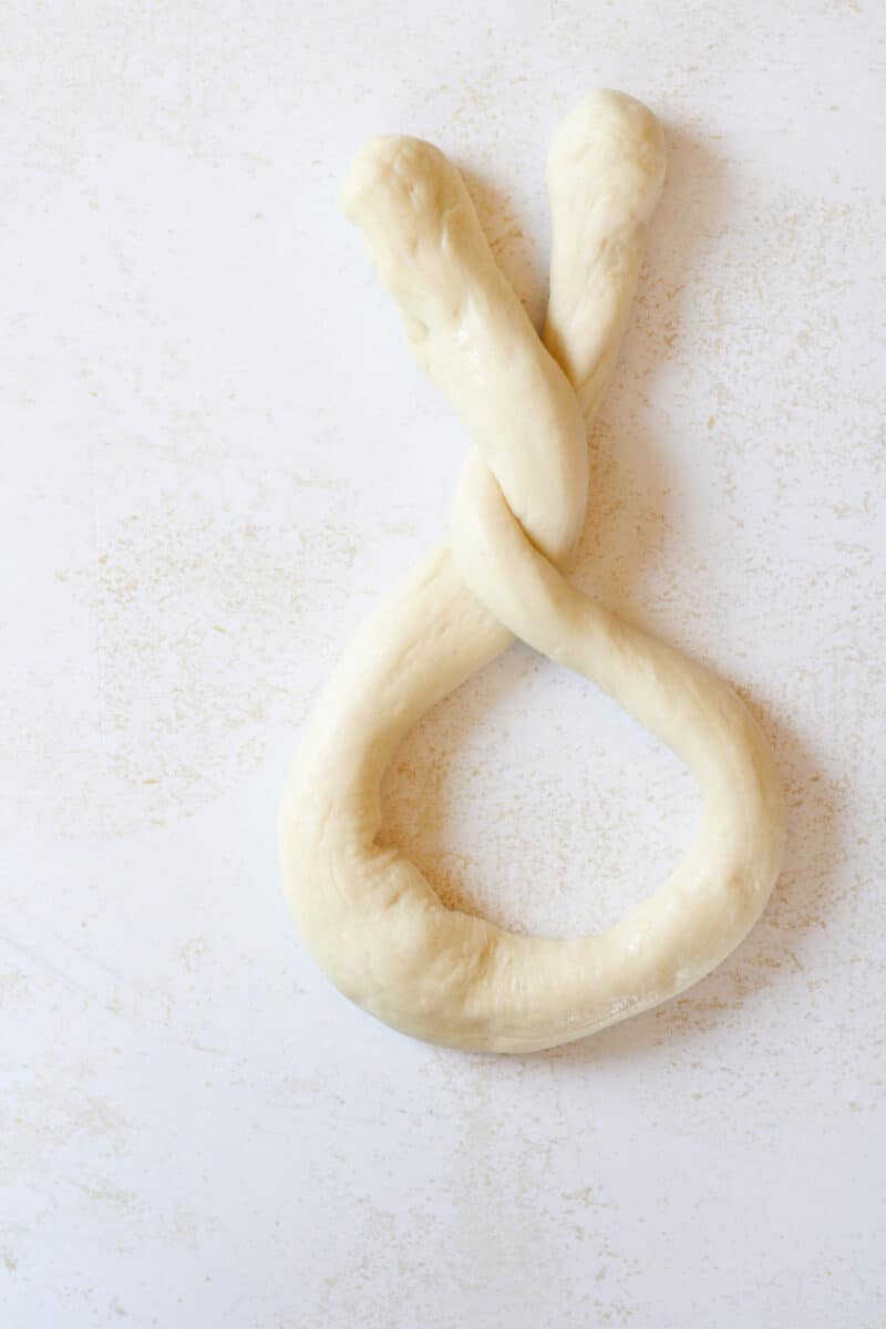 Twisted pretzel dough on a counter.