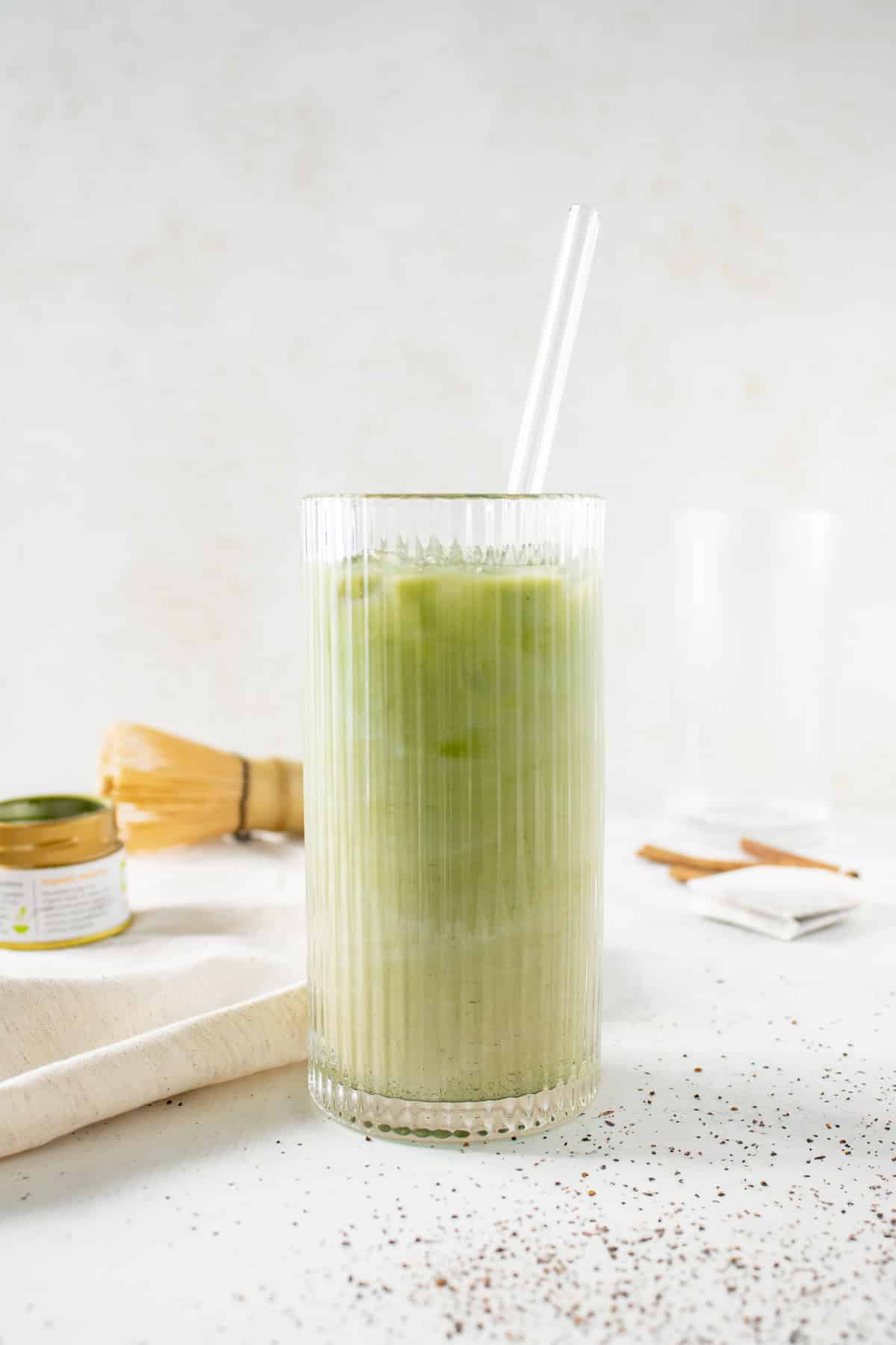 Iced chai matcha in a glass with a straw.